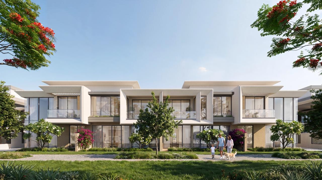 Azizi Florence Sharjah — garden townhouses facing an open lawn