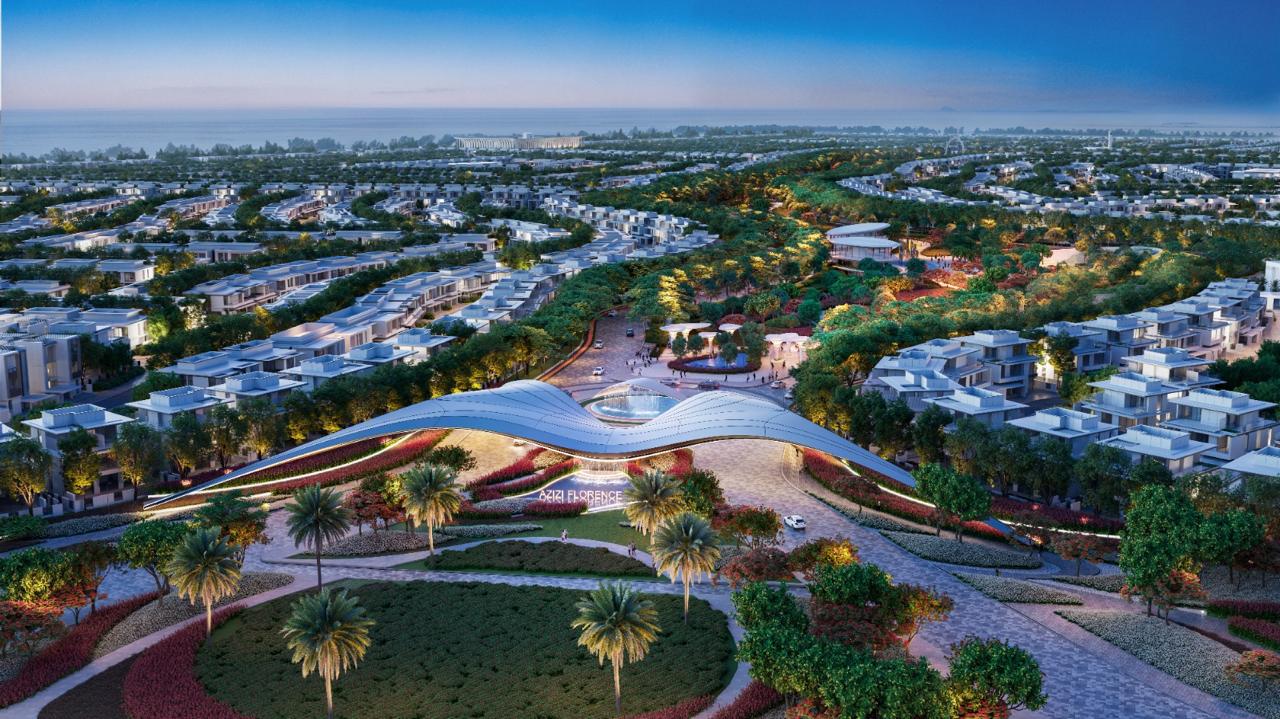 Azizi Florence Sharjah — the community gateway and surrounding clusters at dusk